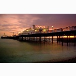 Brighton Pier illuminated at sunset